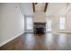 Spacious living room with a stone fireplace, wood beams and hardwood flooring at 5328 Monticello Dr, Villa Rica, GA 30180