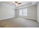 Main bedroom with tray ceiling, ceiling fan, and carpet at 5328 Monticello Dr, Villa Rica, GA 30180