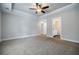 Large main bedroom with tray ceilings, ceiling fan, carpet and bathroom access at 5328 Monticello Dr, Villa Rica, GA 30180
