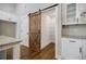 Pantry featuring wood barn door, shelving, and granite countertops at 5328 Monticello Dr, Villa Rica, GA 30180