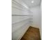 Walk-in pantry features wood floors, wire shelving and recessed lighting at 5328 Monticello Dr, Villa Rica, GA 30180