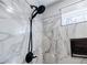 This shower features a black shower head with sleek marbled walls and trim at 5328 Monticello Dr, Villa Rica, GA 30180