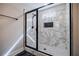 Bathroom boasts marble shower with glass enclosure, rainfall showerhead, and pebble floor at 5328 Monticello Dr, Villa Rica, GA 30180