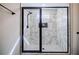 Bathroom displays marble shower with glass enclosure, rainfall showerhead, and pebble floor at 5328 Monticello Dr, Villa Rica, GA 30180
