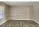 Bedroom featuring a window, neutral walls, base molding and new flooring at 908 Kennesaw Dr, Forest Park, GA 30297