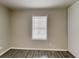 Bedroom featuring a window, neutral walls, base molding, closet and new flooring at 908 Kennesaw Dr, Forest Park, GA 30297