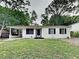 Charming home featuring a lush green front lawn and mature trees at 908 Kennesaw Dr, Forest Park, GA 30297