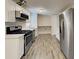 Bright kitchen with stainless steel appliances, white cabinets, light countertop, and new flooring at 908 Kennesaw Dr, Forest Park, GA 30297
