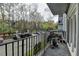 View from the covered balcony with iron railings overlooking the courtyard parking at 3201 Lenox Rd Ne # 13, Atlanta, GA 30324