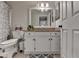 Neutral bathroom featuring a white vanity with granite countertops, framed mirror, and a patterned shower curtain at 3201 Lenox Rd Ne # 13, Atlanta, GA 30324