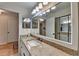 Bathroom featuring granite countertops, vanity with a large mirror, modern lighting, and an entrance door at 3201 Lenox Rd Ne # 13, Atlanta, GA 30324