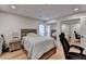 Bright bedroom with a bed, guitar, mirrored closet doors, and a view into another bedroom at 3201 Lenox Rd Ne # 13, Atlanta, GA 30324