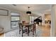 Dining room featuring hardwood floors, a modern chandelier, and open access to the grand piano at 3201 Lenox Rd Ne # 13, Atlanta, GA 30324