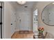 Bright foyer with hardwood floors, white doors, an ornate round mirror, and a view of a bathroom at 3201 Lenox Rd Ne # 13, Atlanta, GA 30324