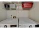 Clean laundry room with a white washer and dryer set and wire shelving above at 3201 Lenox Rd Ne # 13, Atlanta, GA 30324