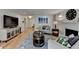 Bright living room features a fireplace, hardwood floors, is decorated with modern furniture, and has neutral walls at 3201 Lenox Rd Ne # 13, Atlanta, GA 30324