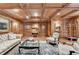 Elegant living room featuring coffered ceilings, wood paneling, sophisticated furniture, and a vintage luggage cart at 3201 Lenox Rd Ne # 13, Atlanta, GA 30324