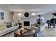 Open living room layout includes fireplace, piano, hardwood floors, and is decorated with modern furniture and art at 3201 Lenox Rd Ne # 13, Atlanta, GA 30324