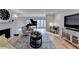 Bright living room features a fireplace, piano, hardwood floors, and lots of natural light from the sliding glass doors at 3201 Lenox Rd Ne # 13, Atlanta, GA 30324