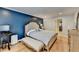 Spacious main bedroom with blue accent wall, walk-in closet, and hardwood floors at 3201 Lenox Rd Ne # 13, Atlanta, GA 30324
