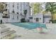 Covered community pool area with lounge chairs and a manicured landscape view at 3201 Lenox Rd Ne # 13, Atlanta, GA 30324