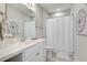 Bathroom featuring white vanity, patterned floor tiles, and shower with white curtain at 525 Springer Nw Bnd, Marietta, GA 30060