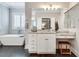 Bathroom featuring a modern vanity with granite countertops, tub and shutters at 525 Springer Nw Bnd, Marietta, GA 30060