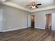 Spacious bedroom with tray ceiling and wood-look flooring at 6420 Olmadison Pl, Atlanta, GA 30349