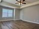 Large bedroom with tray ceiling, ceiling fan, and natural light at 6420 Olmadison Pl, Atlanta, GA 30349