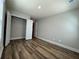 Neutral bedroom showcasing wood-look floors and an open closet with shelving at 6420 Olmadison Pl, Atlanta, GA 30349