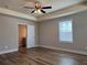 Bright bedroom with ceiling fan, wood flooring, and ensuite bath at 6420 Olmadison Pl, Atlanta, GA 30349