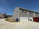 Exterior showcasing the modern townhome design, private driveways, and landscaped surroundings at 6420 Olmadison Pl, Atlanta, GA 30349
