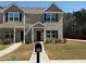 Charming townhome exterior with landscaped lawn and a welcoming entrance at 6420 Olmadison Pl, Atlanta, GA 30349
