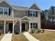 Well-maintained townhome exterior with manicured landscaping and inviting front entrances at 6420 Olmadison Pl, Atlanta, GA 30349