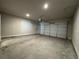 Open garage area with concrete floor, automatic garage door, and convenient overhead lighting at 6420 Olmadison Pl, Atlanta, GA 30349