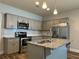 Modern kitchen with stainless steel appliances, granite countertops, and a stylish island at 6420 Olmadison Pl, Atlanta, GA 30349