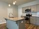 Modern kitchen with stainless steel appliances, granite countertops, and a stylish island at 6420 Olmadison Pl, Atlanta, GA 30349