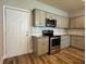 Modern kitchen with stainless steel appliances, granite countertops, and ample cabinet space at 6420 Olmadison Pl, Atlanta, GA 30349