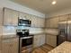 Modern kitchen with stainless appliances, granite countertops, and subway tile at 6420 Olmadison Pl, Atlanta, GA 30349