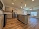 Open kitchen boasts stainless appliances, granite counters, and island at 6420 Olmadison Pl, Atlanta, GA 30349