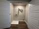 Neat laundry room featuring a wire shelf, floor drain, and modern wood-look flooring at 6420 Olmadison Pl, Atlanta, GA 30349