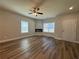 Comfortable living room featuring a ceiling fan, modern fireplace, and plenty of natural light at 6420 Olmadison Pl, Atlanta, GA 30349