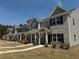 Charming townhome exterior showcasing landscaped lawn and inviting front entrances at 6420 Olmadison Pl, Atlanta, GA 30349