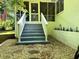 Charming back porch with white railings, steps, stone landscaping, and an American flag at 663 Embry Ln, Marietta, GA 30066