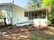 Exterior view of home's fenced backyard, showcasing a screened-in patio and brick planter at 663 Embry Ln, Marietta, GA 30066