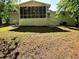 View of the back exterior featuring a screened-in porch, backyard, and stairs at 663 Embry Ln, Marietta, GA 30066