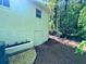 Exterior view of a white home with a small garden and backyard access at 663 Embry Ln, Marietta, GA 30066