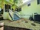 A quaint backyard with stone accents and stairs leading to a screened in back porch area at 663 Embry Ln, Marietta, GA 30066