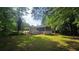 Spacious backyard featuring lush greenery and a charming screened-in porch at 663 Embry Ln, Marietta, GA 30066