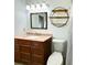 Bathroom with a wooden vanity, granite countertop, and decorative round shelving at 663 Embry Ln, Marietta, GA 30066